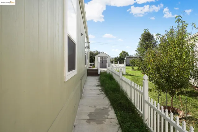 a view of a pathway of a balcony with wooden floor and fence