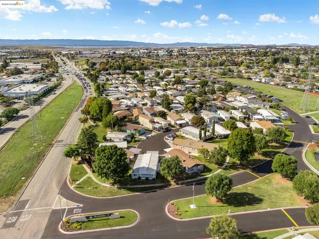 an aerial view of a house with a yard and lake view