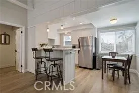 a kitchen with a table chairs refrigerator and microwave