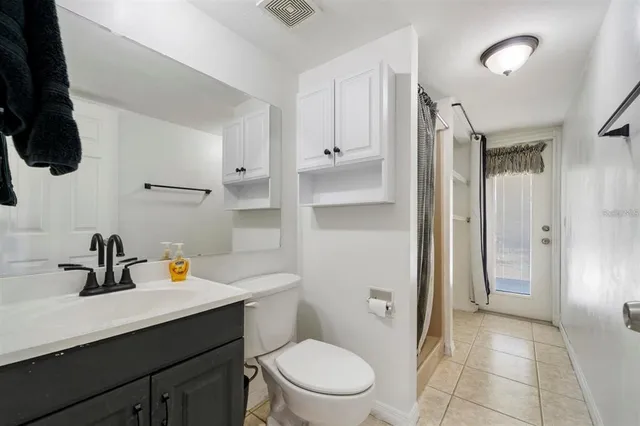 a bathroom with a sink a toilet a shower and a mirror