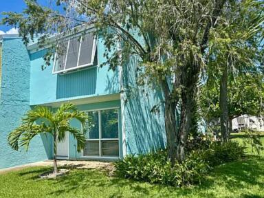 802 Shorewinds Drive, Unit C Fort Pierce, FL 34949 - Photo 1 of 9 a green field with trees in front of it
