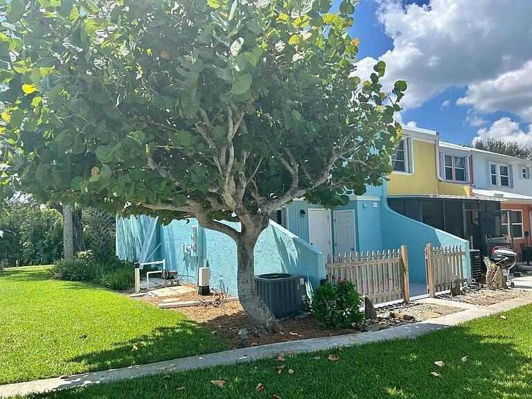 802 Shorewinds Drive, Unit C Fort Pierce, FL 34949 - Photo 9 of 9 a view of a house with backyard and garden