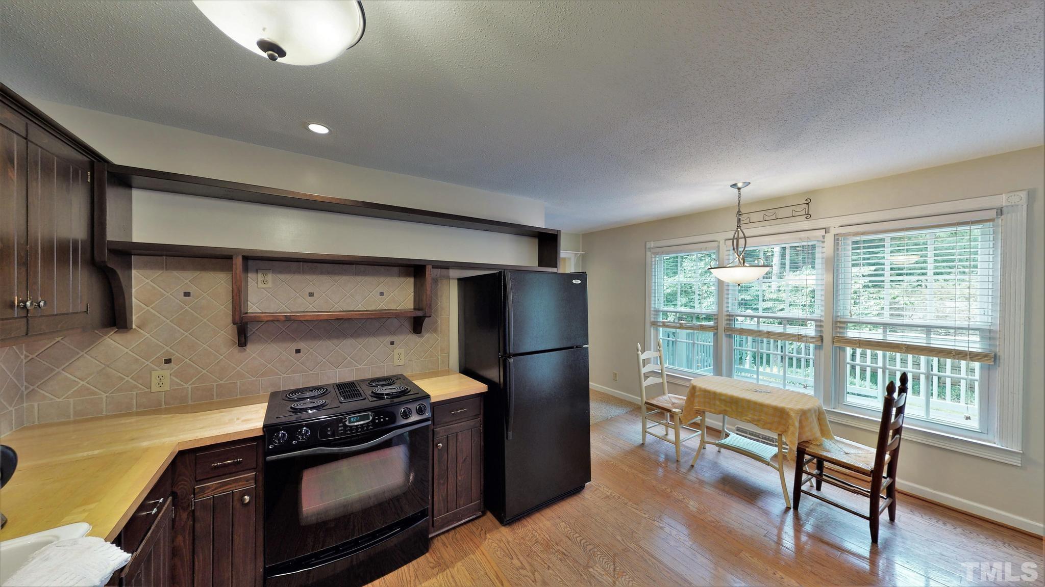 1496 Kerner Road Kernersville, NC 27284 - Photo 13 of 82 a kitchen with stainless steel appliances granite countertop a stove and a refrigerator