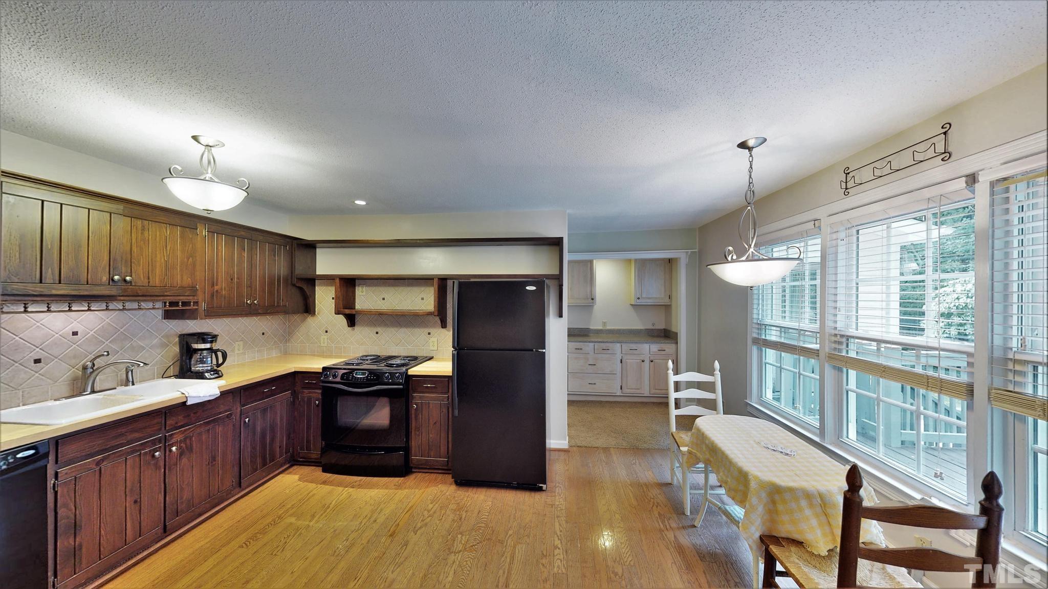 1496 Kerner Road Kernersville, NC 27284 - Photo 14 of 82 a kitchen with stainless steel appliances granite countertop a refrigerator and a sink