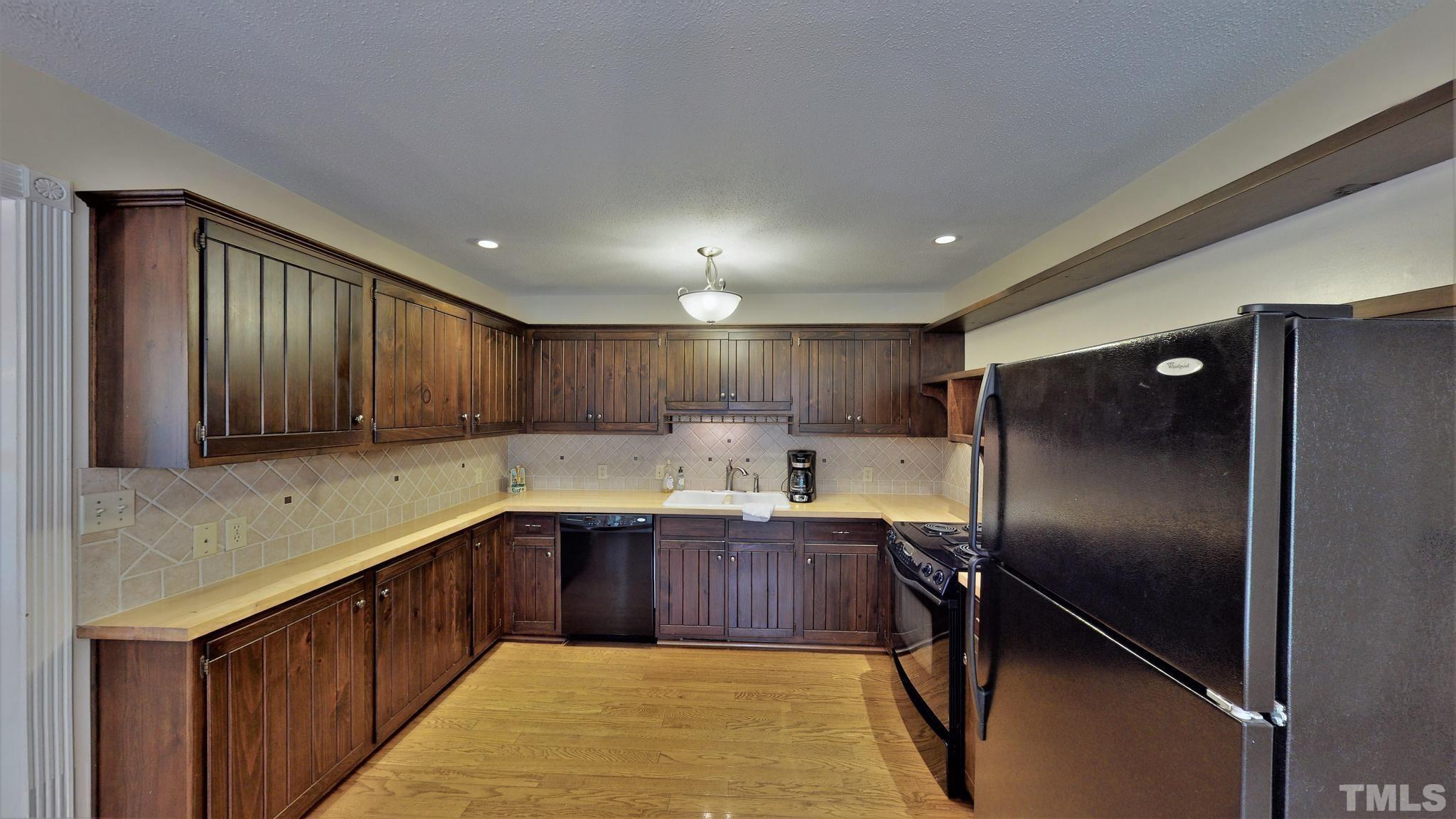1496 Kerner Road Kernersville, NC 27284 - Photo 15 of 82 a kitchen with stainless steel appliances granite countertop a sink refrigerator and cabinets