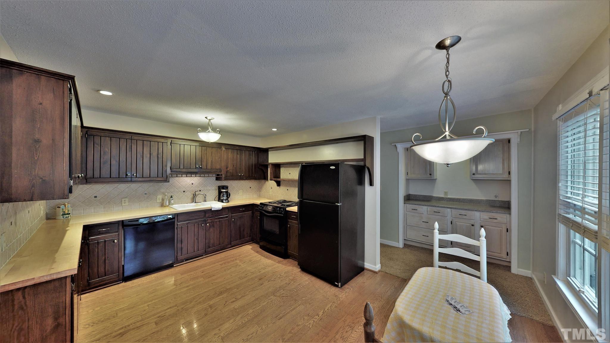 1496 Kerner Road Kernersville, NC 27284 - Photo 19 of 82 a kitchen with kitchen island granite countertop stainless steel appliances and a sink