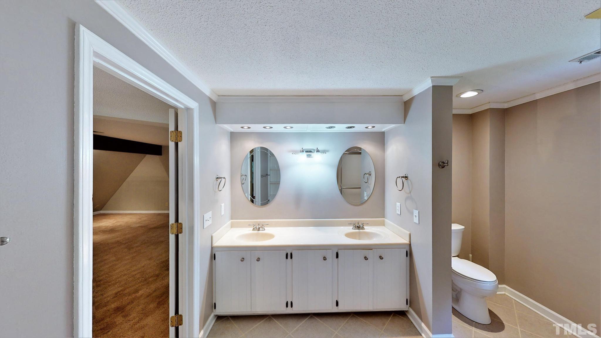 1496 Kerner Road Kernersville, NC 27284 - Photo 44 of 82 a bathroom with a double vanity sink toilet and mirror