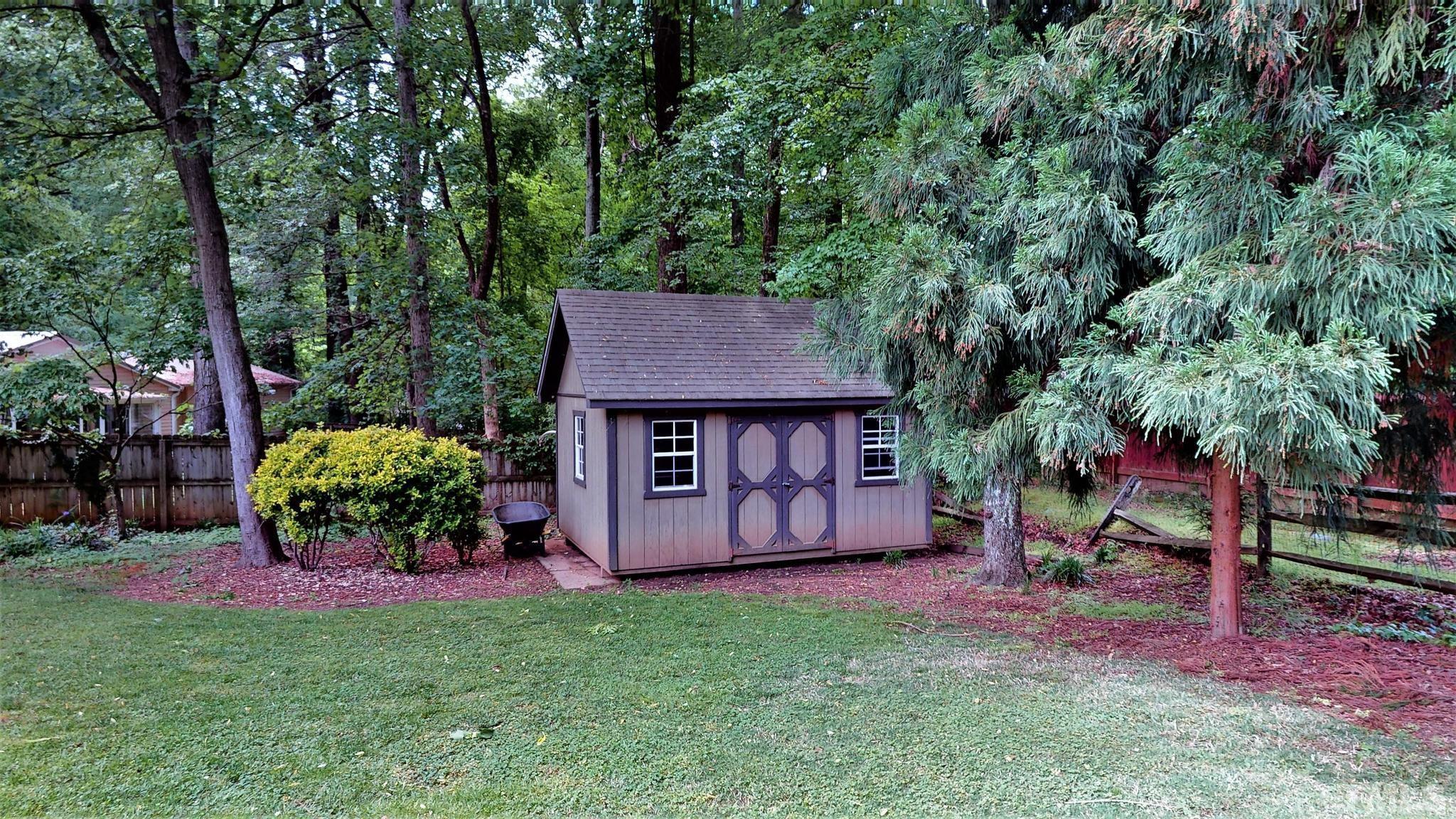 1496 Kerner Road Kernersville, NC 27284 - Photo 80 of 82 a view of a backyard with potted plants and large trees