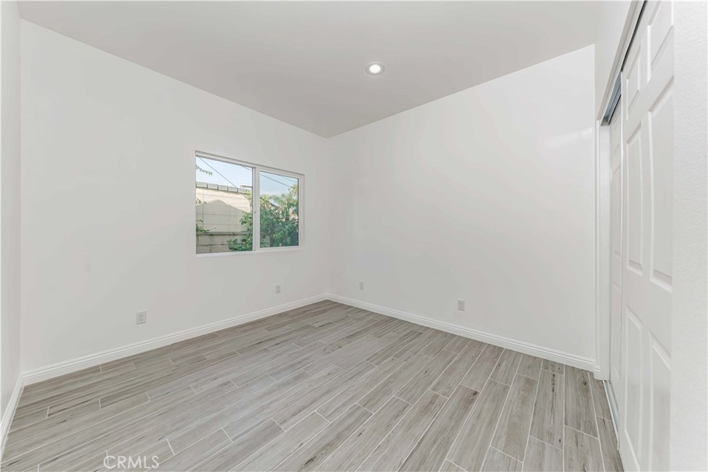 12615 George Street Garden Grove, CA 92840 - Photo 12 of 24 an empty room with wooden floor and windows