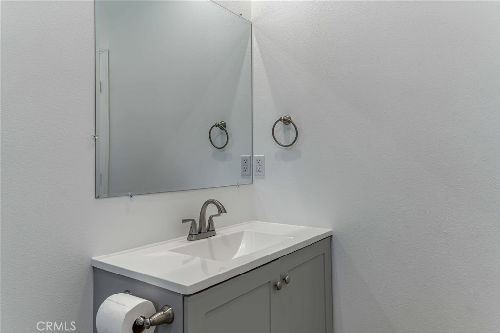 12615 George Street Garden Grove, CA 92840 - Photo 15 of 24 a bathroom with a sink and mirror