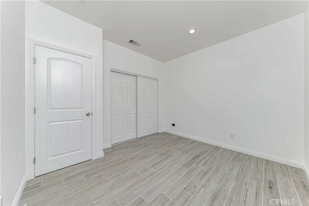 12615 George Street Garden Grove, CA 92840 - Photo 18 of 24 a view of an empty room with wooden floor
