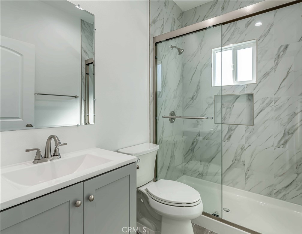 12615 George Street Garden Grove, CA 92840 - Photo 20 of 24 a bathroom with a sink toilet and shower