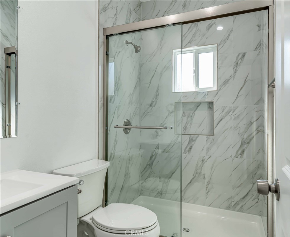 12615 George Street Garden Grove, CA 92840 - Photo 21 of 24 a bathroom with a sink a toilet and shower