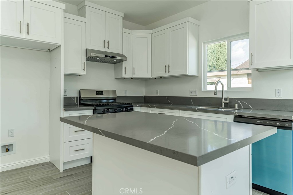 12615 George Street Garden Grove, CA 92840 - Photo 7 of 24 a kitchen with stainless steel appliances granite countertop a sink stove and cabinets