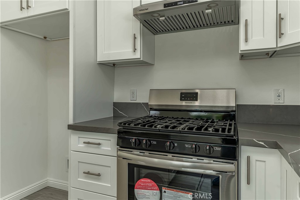 12615 George Street Garden Grove, CA 92840 - Photo 10 of 24 a stove top oven sitting inside of a kitchen