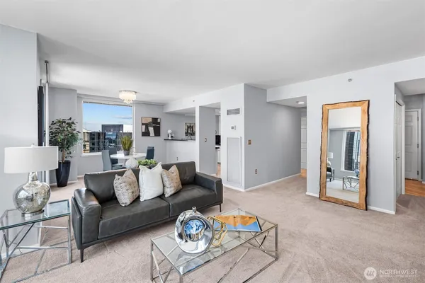 a living room with furniture and a dining table