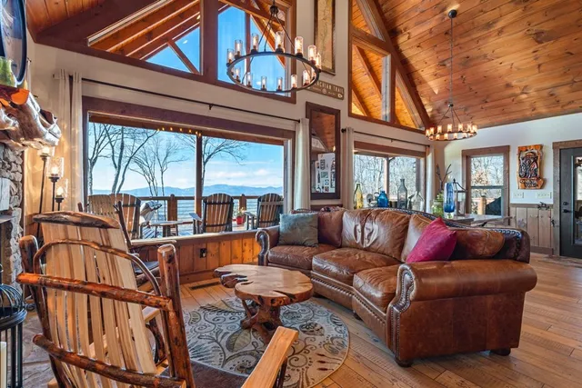 a bedroom with a large bed a flat tv screen and dresser