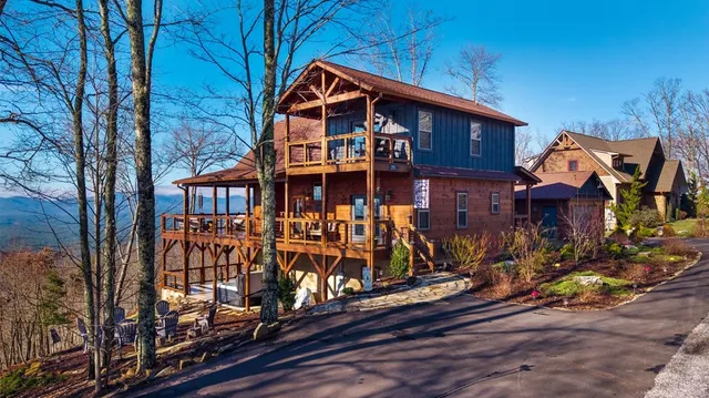 a view of a balcony with chairs and wooden floor