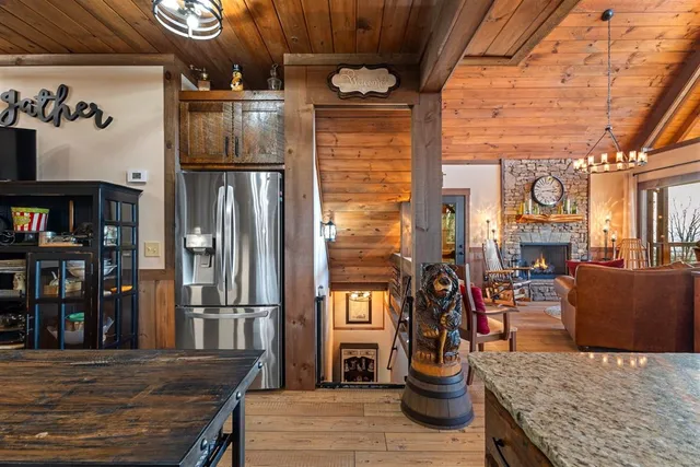 a bathroom with a granite countertop sink a toilet a mirror and shower