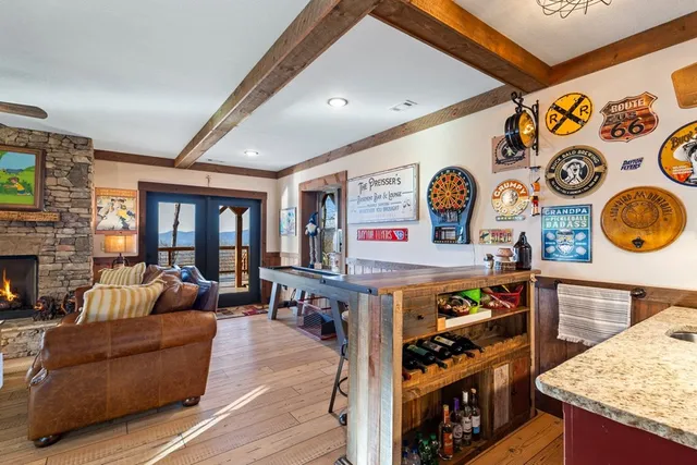 a view of a patio with table and chairs potted plants and large tree