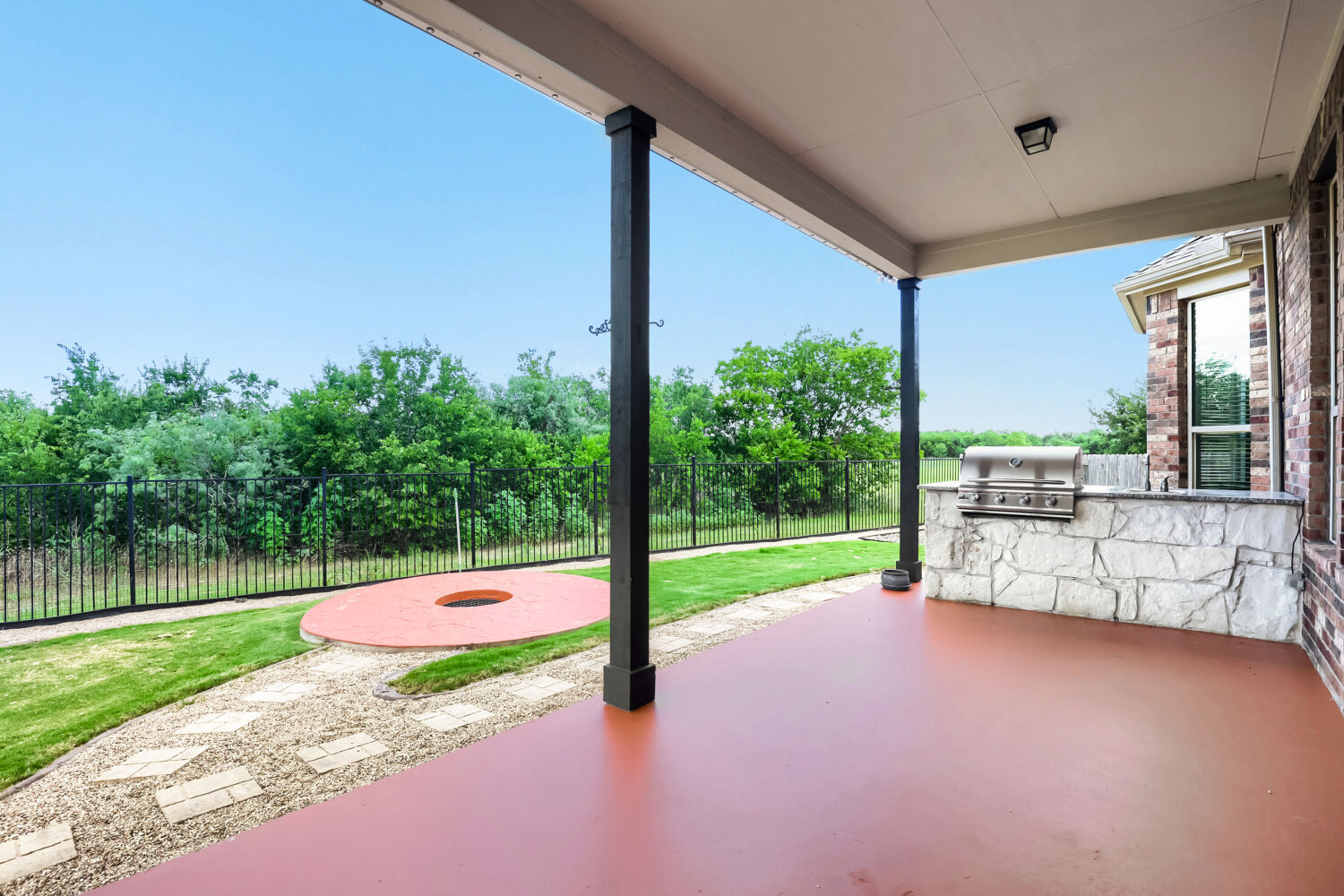 19205 Burrowbridge Road Pflugerville, TX 78660 - Photo 30 of 38 Giant covered patio with outdoor kitchen, luxury grill (2026), sink, firepit, and plenty of space to unwind with greenbelt views