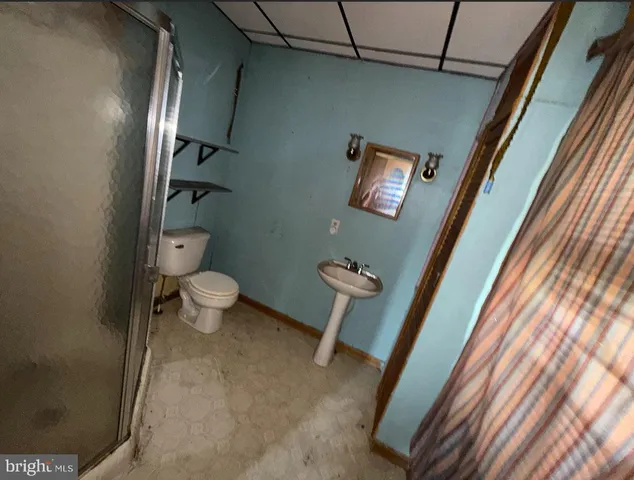 a bathroom with a toilet and a mirror