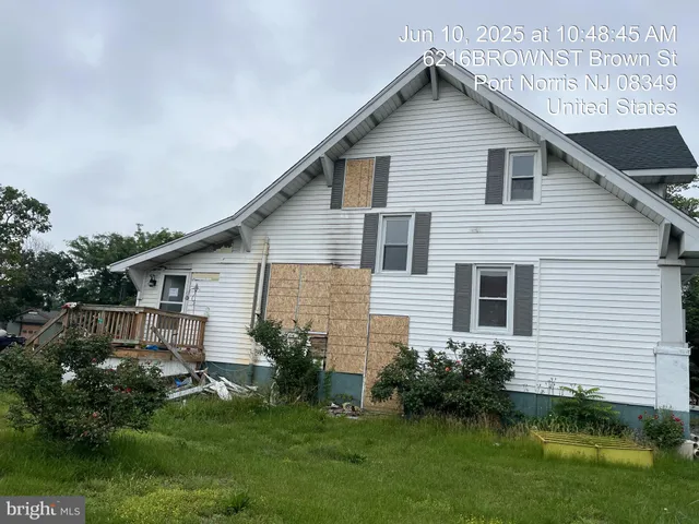 a front view of house with a garden