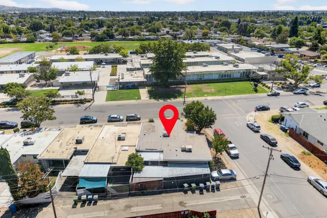 an aerial view of a residential houses with city view