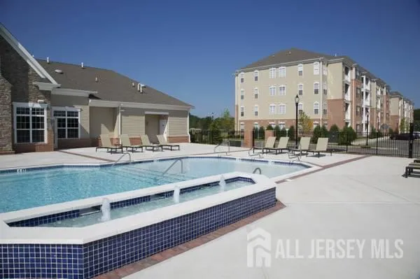 a view of tall building with large windows and a palm tree