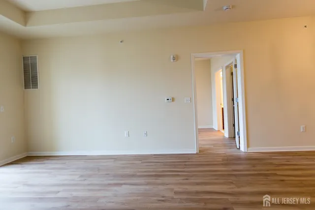 a view of a room with wooden floor