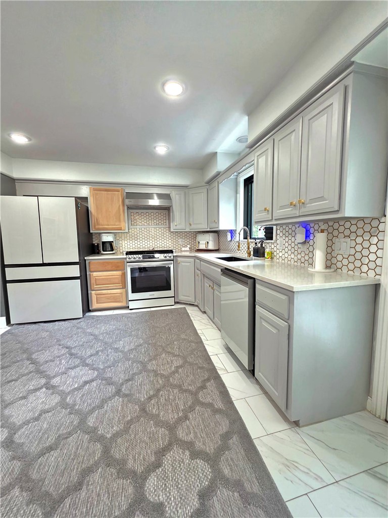 20050 Highway 102 Decatur, AR 72722 - Photo 17 of 30 Kitchen featuring light gray cabinetry, white countertops, hexagonal tile backsplash, stainless steel appliances, and recessed lighting