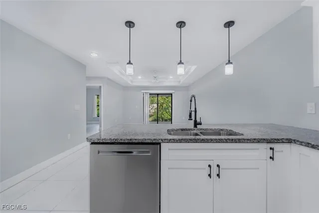 a bathroom with a granite countertop sink and a wooden floor