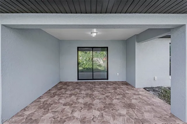 an aerial view of a city with lots of residential buildings ocean and mountain view in back