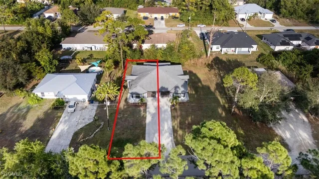 a backyard of a house with a yard and outdoor seating