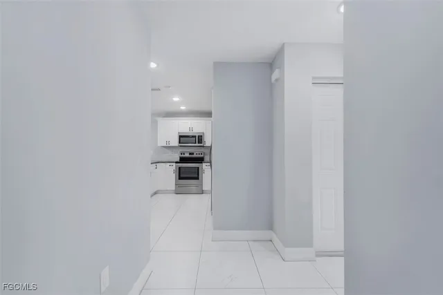 a kitchen with stainless steel appliances a refrigerator and a stove top oven
