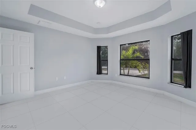 a view of an empty room with window and stairs