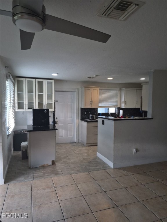 114 Oleander Road Lehigh Acres, FL 33936 - Photo 3 of 17 a kitchen with kitchen island cabinets and refrigerator