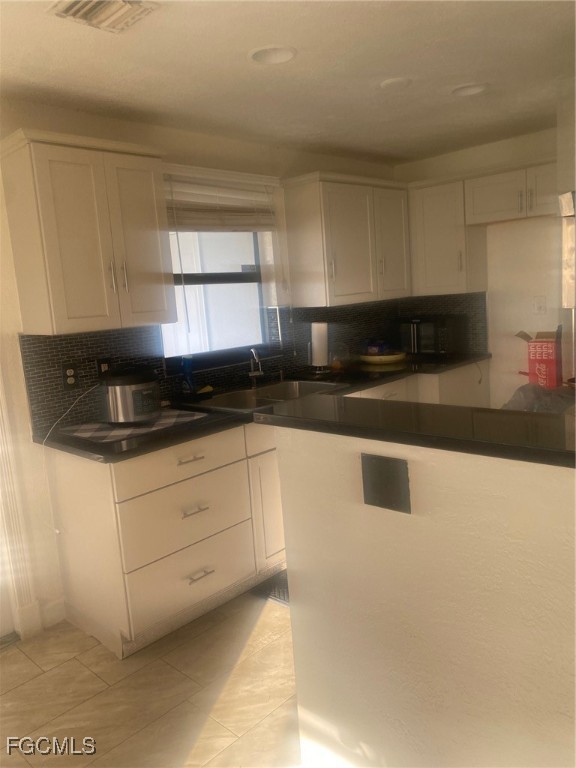 114 Oleander Road Lehigh Acres, FL 33936 - Photo 4 of 17 a kitchen with granite countertop white cabinets and a sink