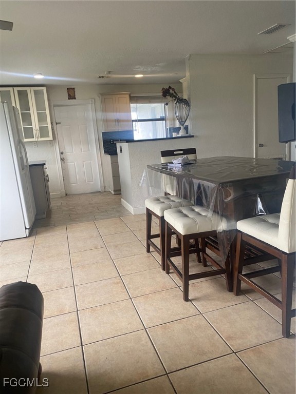 114 Oleander Road Lehigh Acres, FL 33936 - Photo 7 of 17 a kitchen with a sink a stove and a table