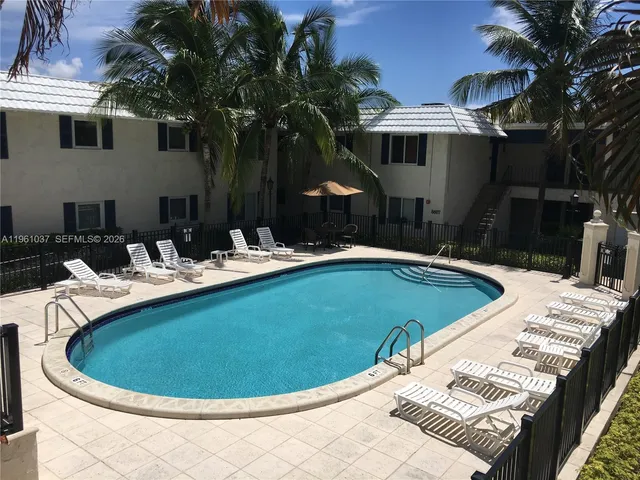 a view of a patio with table and chairs and potted plants
