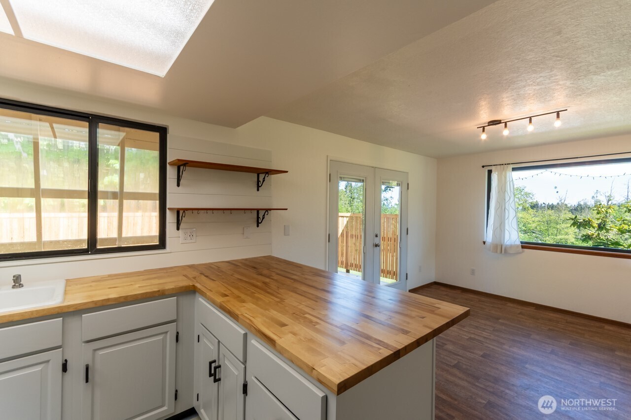 63 East Arnette Road Port Angeles, WA 98362 - Photo 16 of 40 a kitchen with a wooden floor window and wooden floor