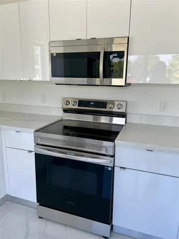 a utility room with wooden floor washer and dryer