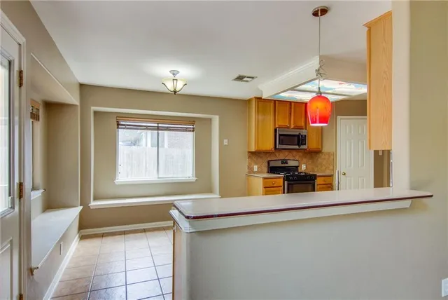 a view of a kitchen with a sink and a window