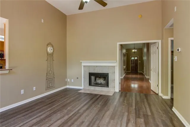 a view of a livingroom with wooden floor and a fireplace