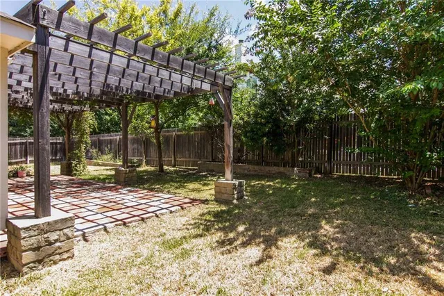 a view of a house with backyard and a tree