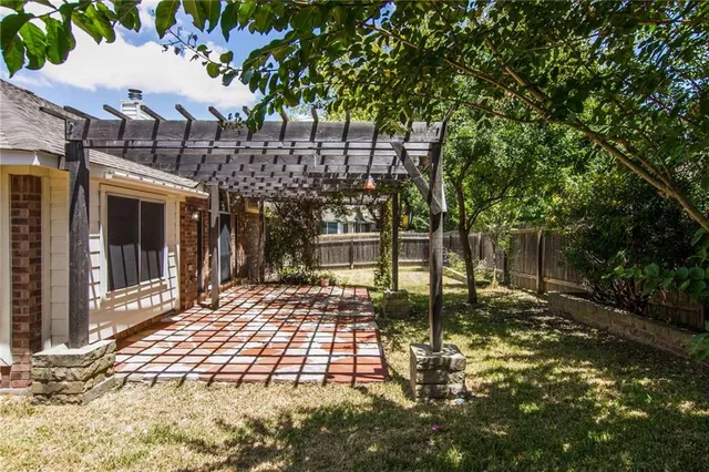a view of a house with a large tree