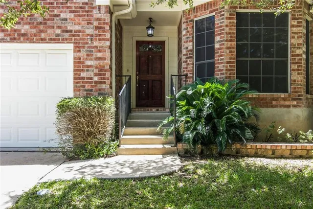 a couple of potted plants in front of door