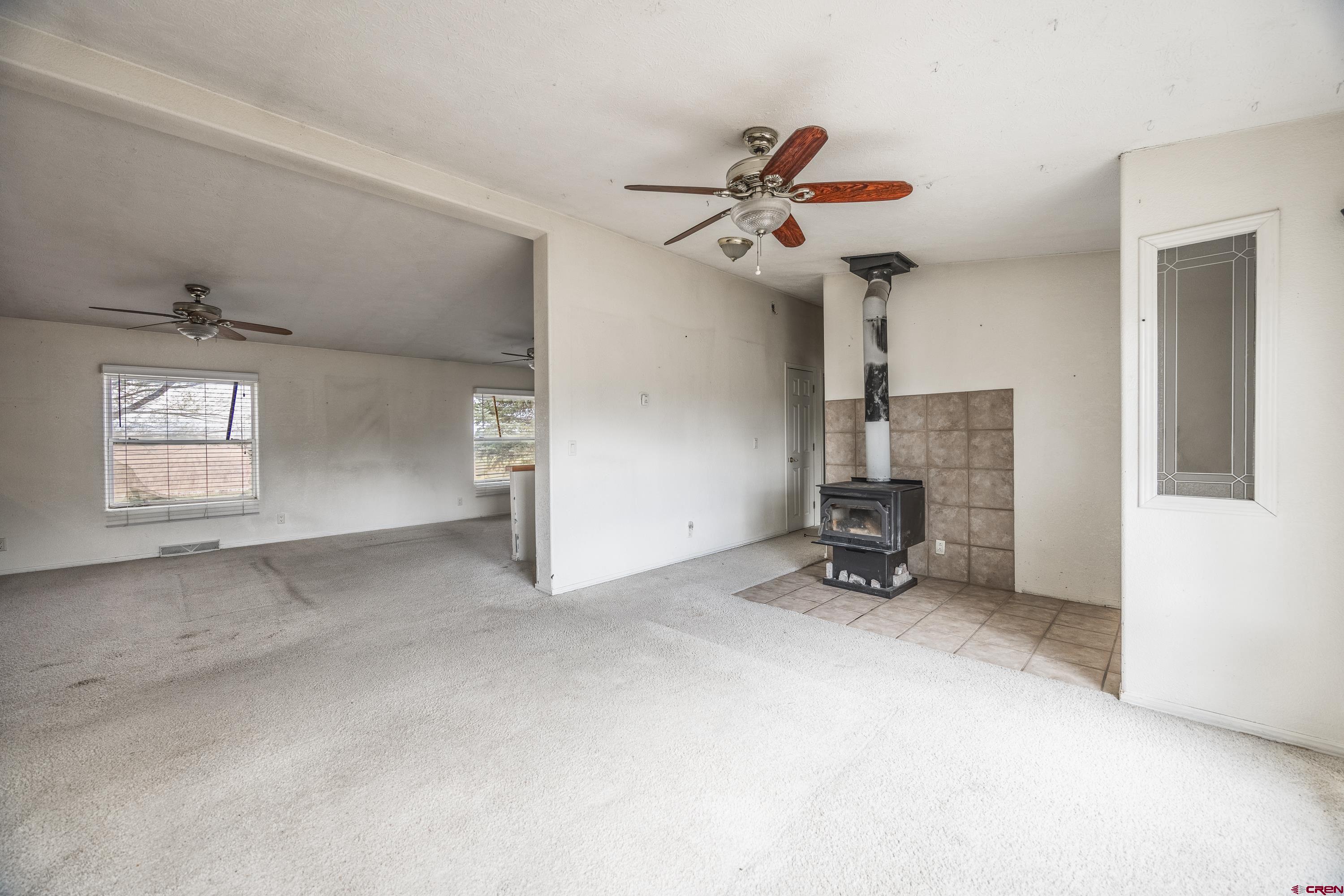 17377 Breeze Road Delta, CO 81416 - Photo 22 of 45 a view of a livingroom with a fireplace and a window