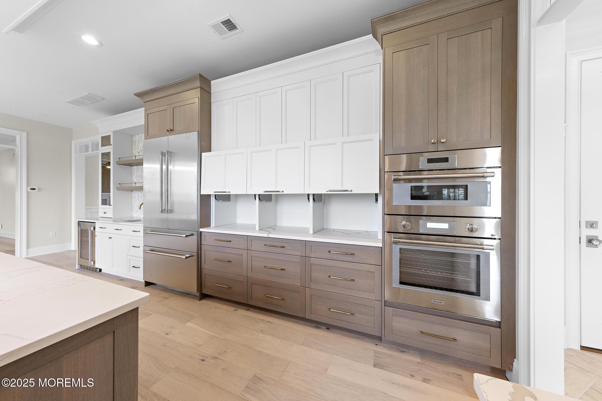 1604 Marconi Road Wall, NJ 07719 - Photo 31 of 69 a kitchen with white cabinets and stainless steel appliances