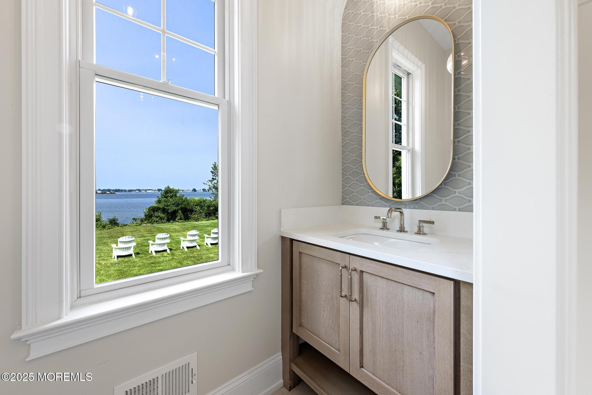 1604 Marconi Road Wall, NJ 07719 - Photo 36 of 69 a bathroom with a sink and a mirror